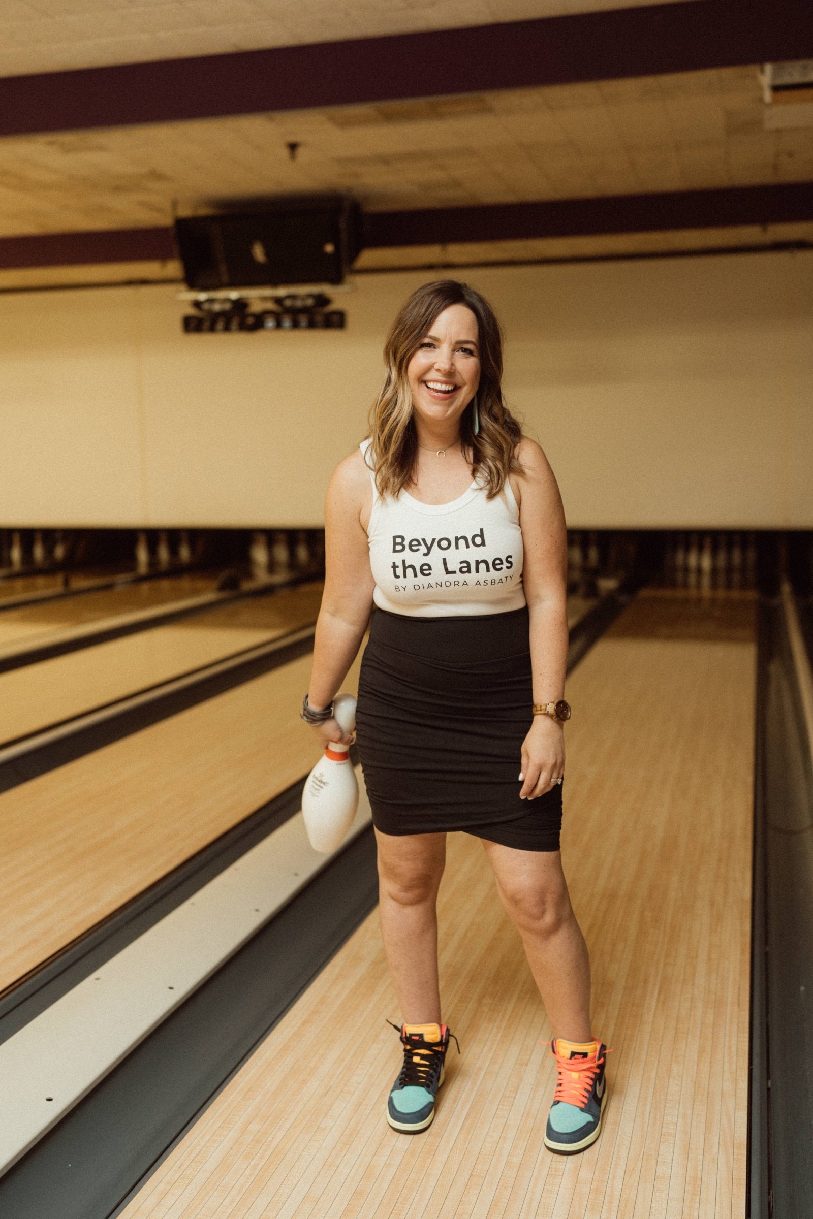 Diandra Asbaty smiling on the lanes in a Beyond the Lanes tank top