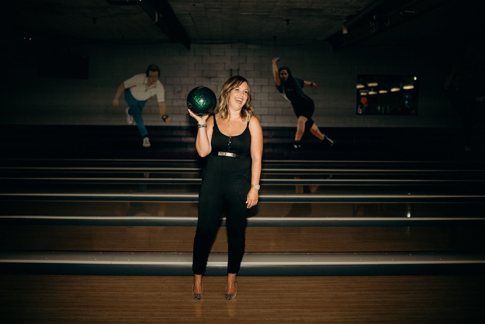 Diandra Asbaty centered on the lanes with bowlers in motion behind her