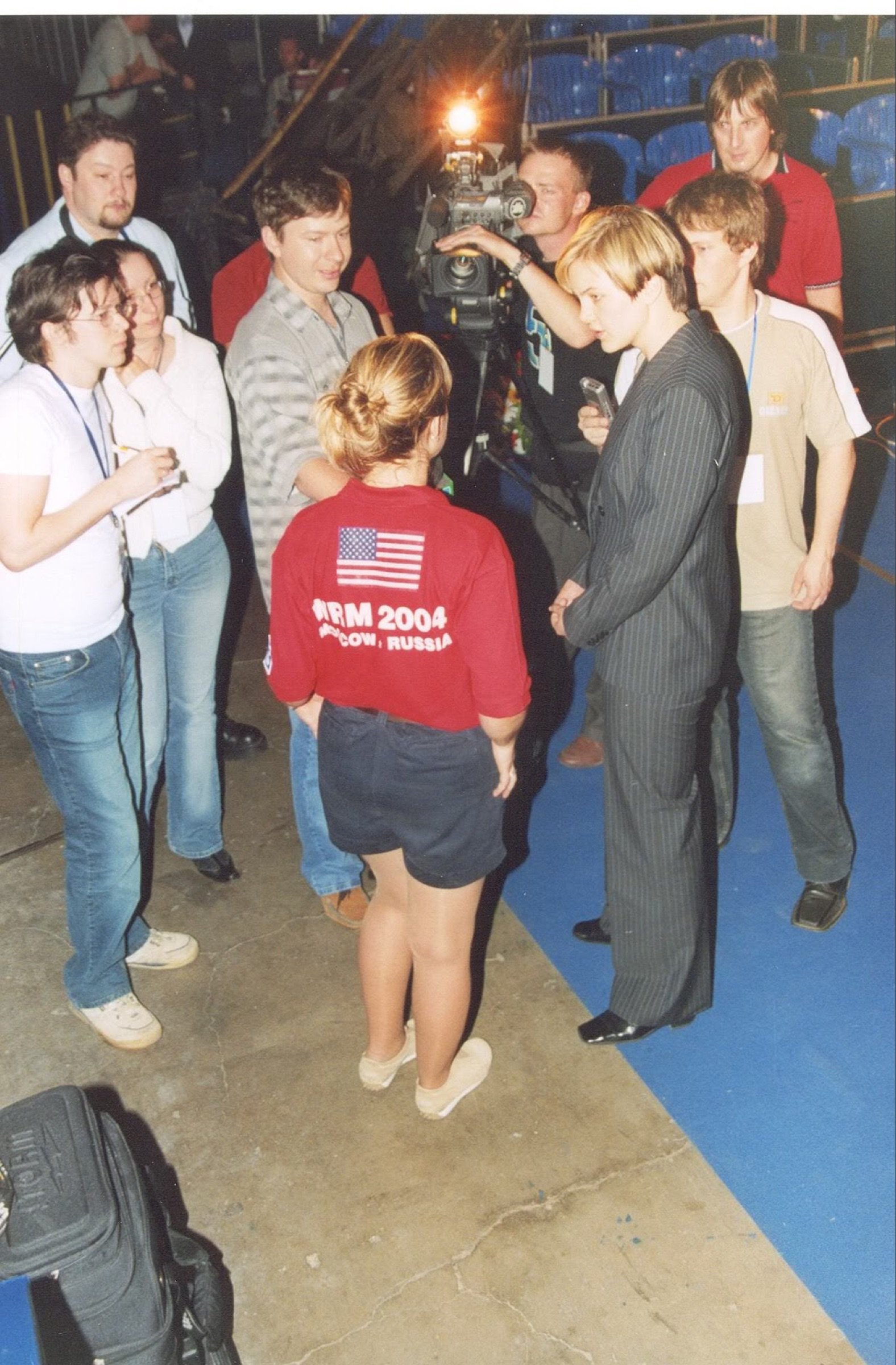 Diandra in her red USA jersey surrounded by Russian press at the 2004 World Ranking Masters